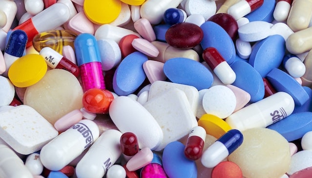 pile of different colored pharmaceutical drugs and pills